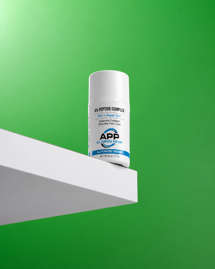 A white bottle of APP Peptide Complex All Flavor Cream with a blue and white label, displayed on a white geometric platform against a vibrant green background.